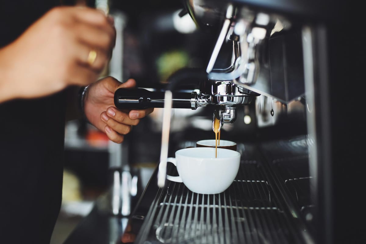 person using espresso machine