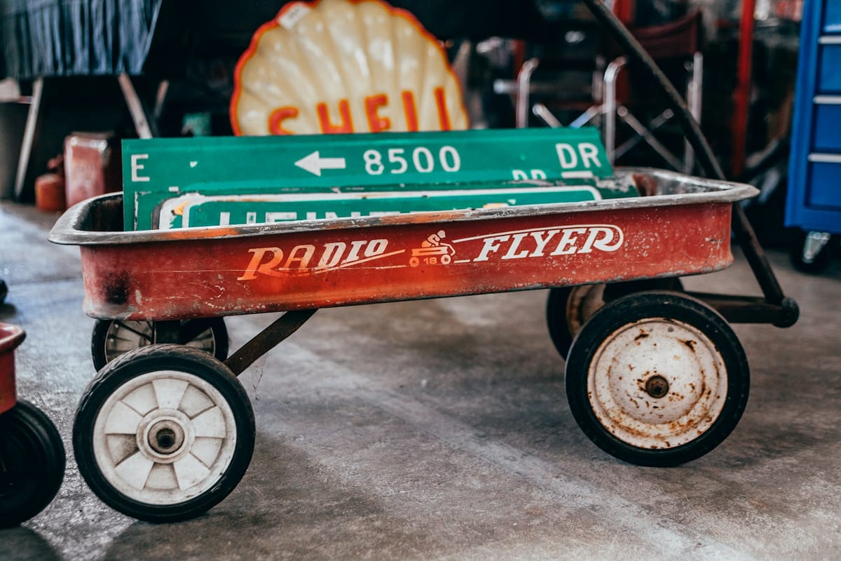 green street signage on red pull wagon