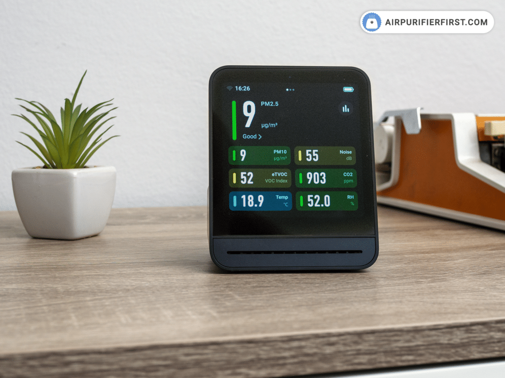 Qingping Gen 2 air quality monitor on a desk - best home air quality monitor 2026