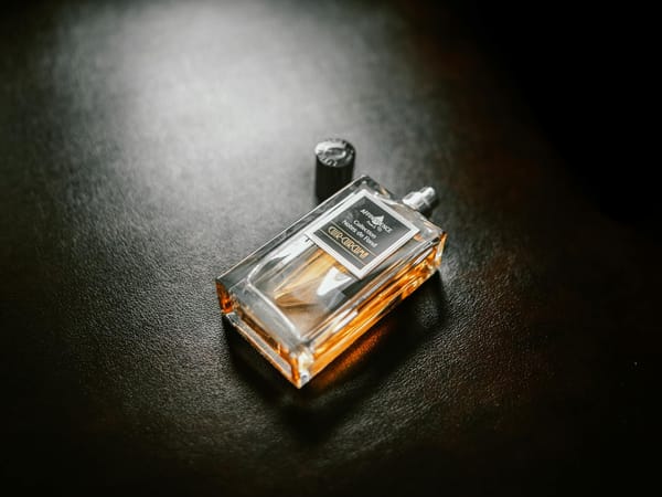 a bottle of perfume on a black background