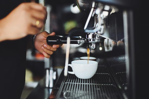 person using espresso machine