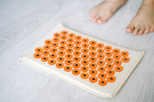 close up of a person next to medical massage mat