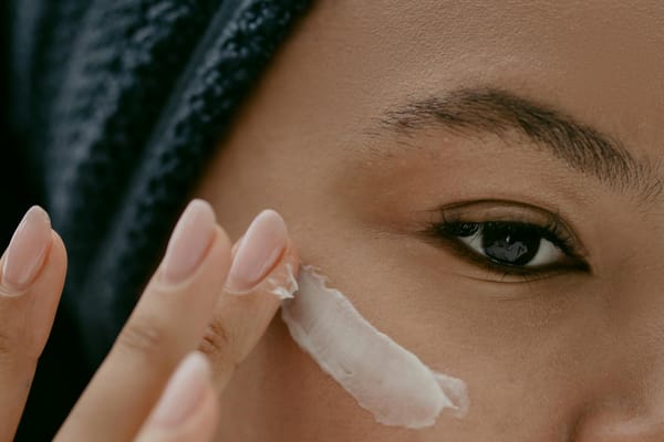 woman applying facial cream on face